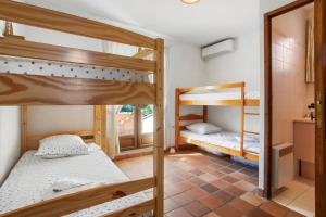 a room with two bunk beds and a mirror at Villa Elisabeth in Fréjus +25 photos