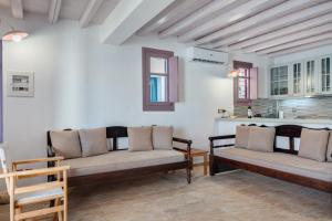 a living room with two benches and a kitchen at Nicolas House 2 in Rakhídhion +17 photos
