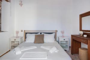 a bedroom with a bed with two towels on it at Nicolas House 2 in Rakhídhion