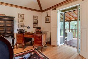 an office with a desk and a sliding glass door at Quinta de Amares in Amares