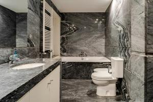 a bathroom with a toilet and a sink and a tub at Quinta de Amares in Amares +35 photos
