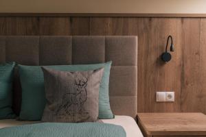 a bed with a pillow with a deer on it at Balbeinhof Apt Hirsch in Luson