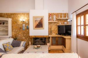 a living room with a couch and a fireplace at Finca Kelly in Artá