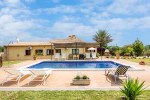 a villa with a swimming pool and a house at Finca Kelly in Artá
