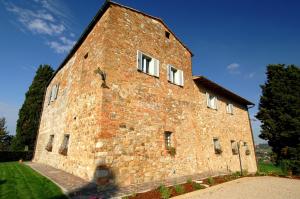 a large brick building with white windows on it at Villa Arnilù in San Gimignano