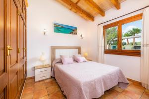 a bedroom with a bed and a window at Finca Kelly in Artá +22 photos