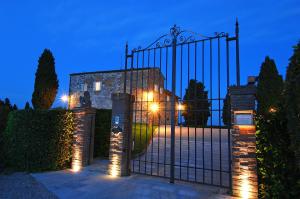 a gate in front of a building with lights at Villa Arnilù in San Gimignano +5 photos