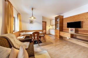 a living room with a couch and a dining room at Florerhof Ferienwohnung Lavendel in Vols am Schlern