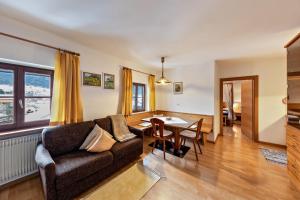 a living room with a couch and a table at Florerhof Ferienwohnung Lavendel in Vols am Schlern