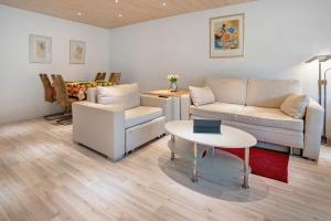 a living room with two couches and a table at Fewo Talblick mit Schwimmbad in Bad Wildbad
