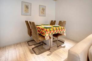 a dining room table with chairs and a table cloth at Fewo Talblick mit Schwimmbad in Bad Wildbad