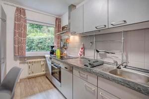 a kitchen with a sink and a counter top at Fewo Talblick mit Schwimmbad in Bad Wildbad +23 photos