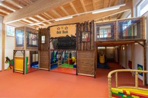 a room with a play room with a playground at Chalet Zur Auszeit in Aschau