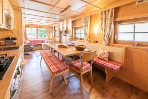 a kitchen and dining room with a table and chairs at Chalet Zur Auszeit in Aschau