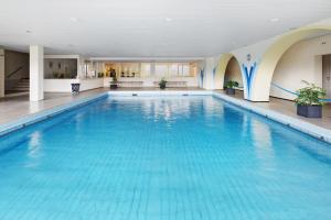 a large blue swimming pool in a building at Ferienwohnung Sally in Lenzkirch