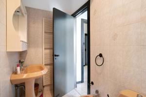a bathroom with a sink and a toilet and a door at Capriccio in Bordighera +17 photos