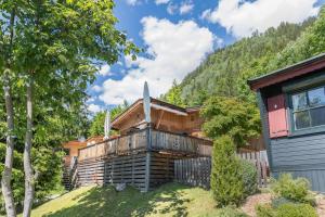 a log cabin in the mountains with a house at Chalet Zur Auszeit in Aschau