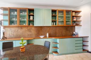 a kitchen with blue cabinets and a table at Capriccio in Bordighera