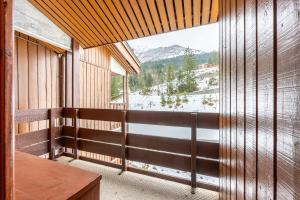 a balcony with a view of a snow covered mountain at Lauziere dessus 50 in Valmorel