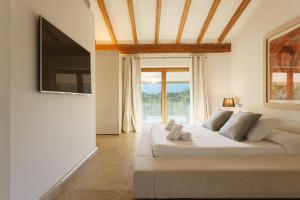 a bedroom with a bed with a teddy bear on it at Finca Playa Llenaire - Can Pou in El Port
