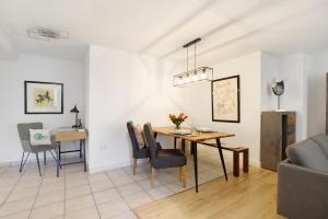 a dining room and living room with a table and chairs at Waldmariechen in Neresheim