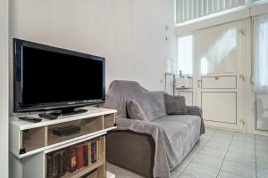 a living room with a couch and a flat screen tv at Fewo Eg Links - Hunde erlaubt in Oberteuringen