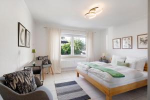 a bedroom with a bed and a chair and a window at Waldmariechen in Neresheim