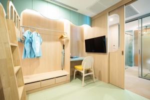 a dressing room with a desk and a tv at Katathani Phuket Beach Resort - SHA Extra Plus in Kata Beach