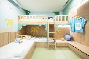 a bunk bed room with two bunk beds at Katathani Phuket Beach Resort - SHA Extra Plus in Kata Beach +134 photos