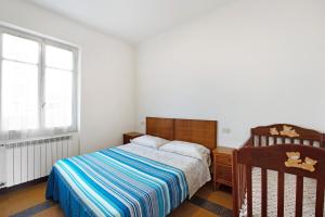 a bedroom with a bed and a window at Dai Baccino in Celle Ligure