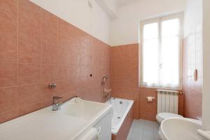 a bathroom with a tub and a sink and a toilet at Dai Baccino in Celle Ligure +16 photos