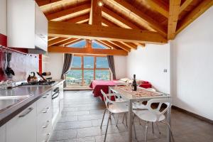 a kitchen with a table and chairs in a room at La Maison De Carletto in Sarre +23 photos