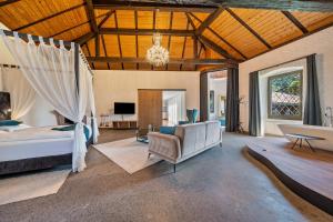a bedroom with a bed and a living room at Thanhammer Apt Quarz in Terlano
