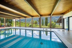 an indoor swimming pool with a view of the mountains at Thanhammer Apt Quarz in Terlano
