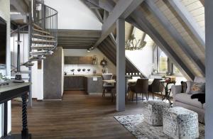 an attic kitchen and living room with a dining room at Kuckucks Hideaway in Oberibach