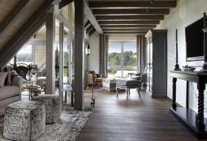 a living room with a couch and a fireplace at Kuckucks Hideaway in Oberibach