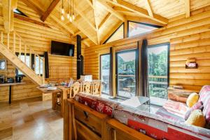 a living room with wooden walls and a large window at Chalet Agréable 3 étoiles app 4 in Courchevel