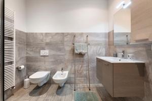 a bathroom with a toilet and a sink at La Casa Di Beppe - Val d'Intelvi in Lanzo dʼIntelvi