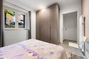 a bedroom with a bed and a window at La Casa Di Beppe - Val d'Intelvi in Lanzo dʼIntelvi