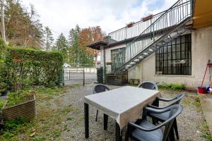 a table and chairs in front of a building at La Casa Di Beppe - Val d'Intelvi in Lanzo dʼIntelvi
