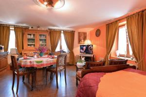 a room with a dining table and a bedroom at Les Pruniers - Orbey in Orbey +17 photos