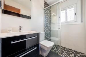 a bathroom with a sink and a toilet and a shower at Creixell in Creixell +17 photos