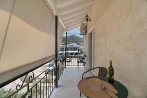 a balcony with a table and a bottle of wine at M2 room in Nikiana