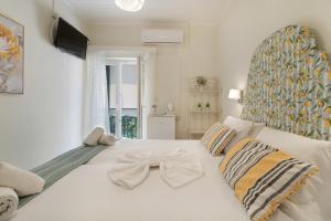 a large white bed with a bow tie on it at M2 room in Nikiana +11 photos
