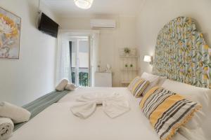 a bedroom with a white bed with a bow tie on it at M2 room in Nikiana