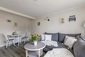 a living room with a couch and a table at Ferienhaus Nilsson in Heide