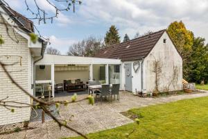 a patio with a table and chairs next to a building at Ferienhaus Nilsson in Heide