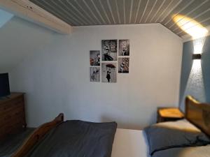 a bedroom with pictures on the wall at Zimmer in Müsch nahe Nürburgring in Müsch