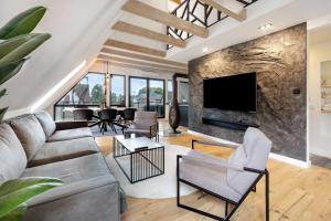 a living room with a large stone wall at Penthouse Kokorey in Halstenbek