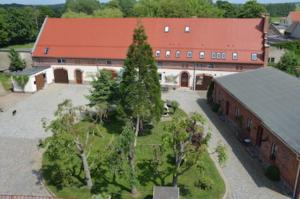 an aerial view of a building with a tree in front of it at Ferienwohnungen Bunge in Krostitz